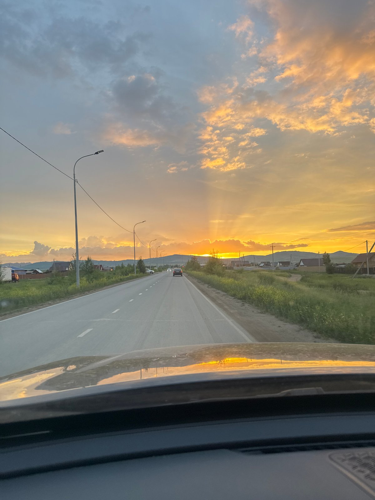 Rural road trip wraps up under a golden sunset sky