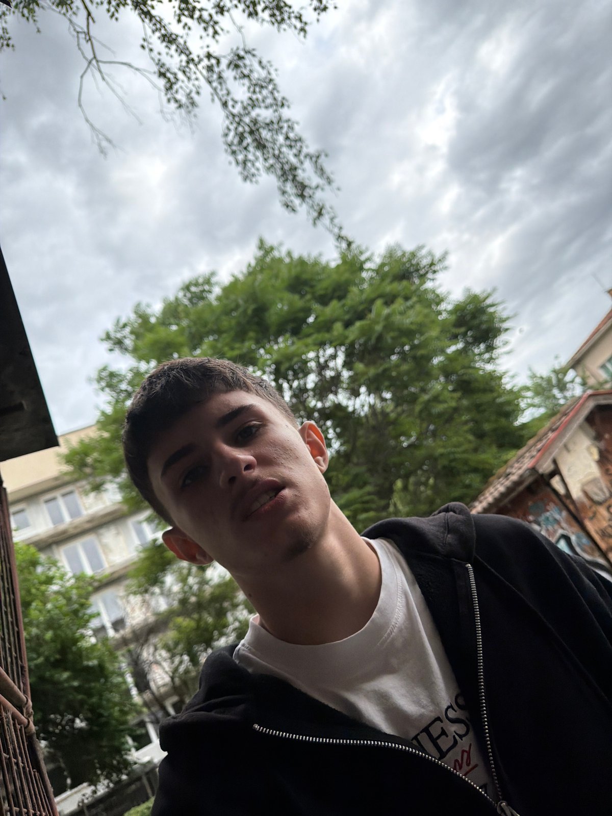 Young people gather on Plovdiv sidewalk in casual morning meetup