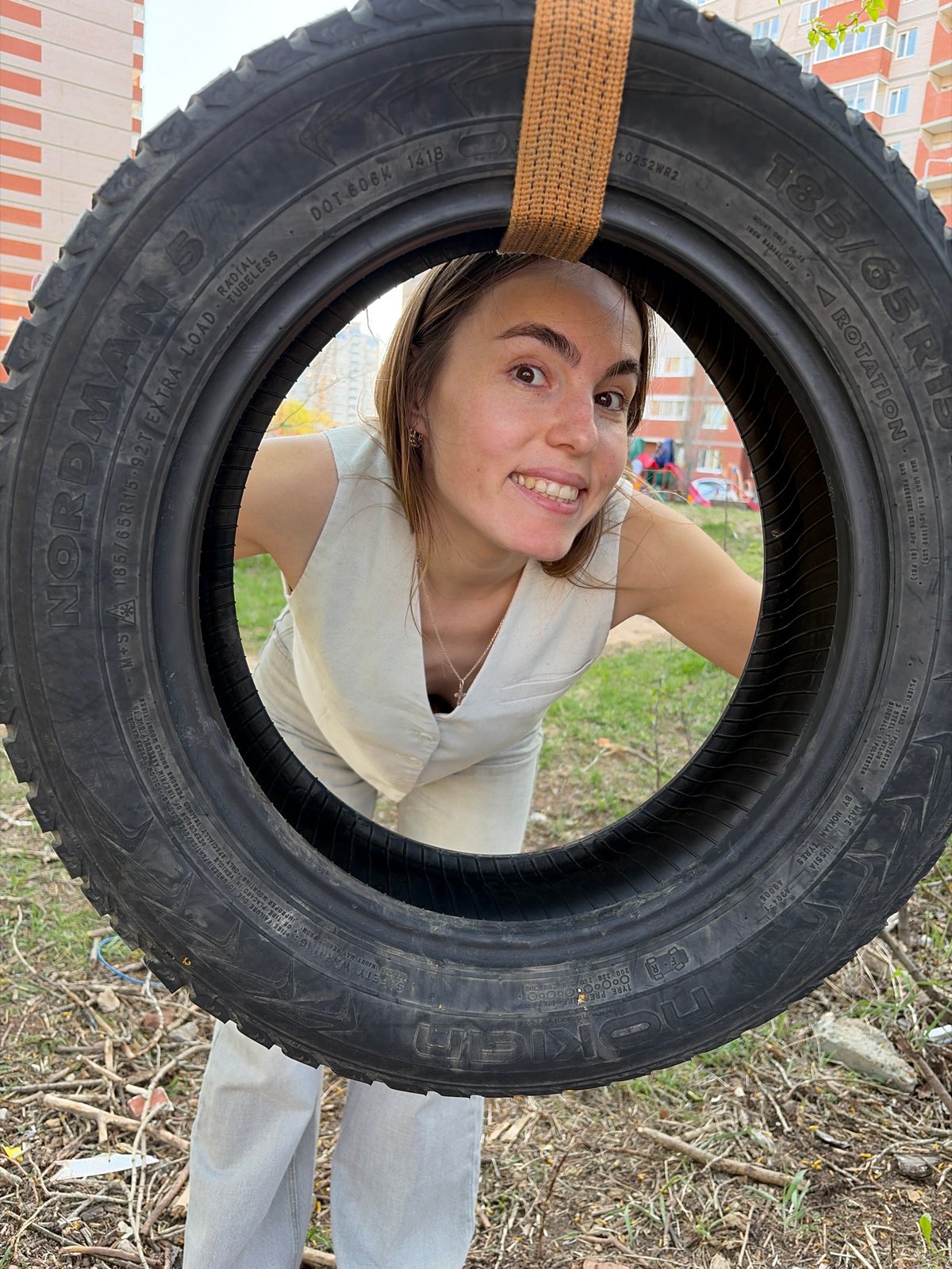 Child plays on tire swing at Izhevsk playground