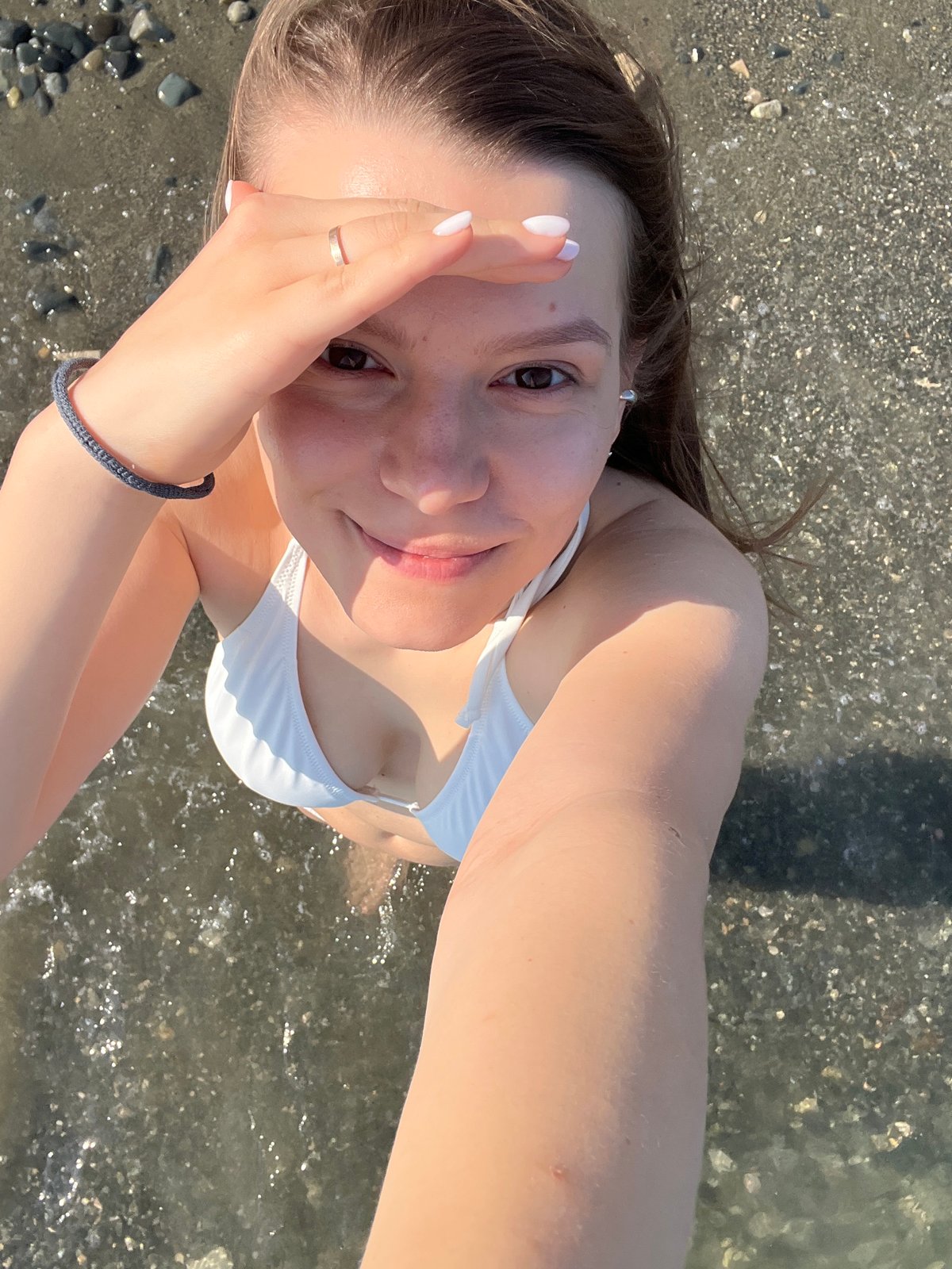 Woman enjoys beach day in Cyprus, takes selfies