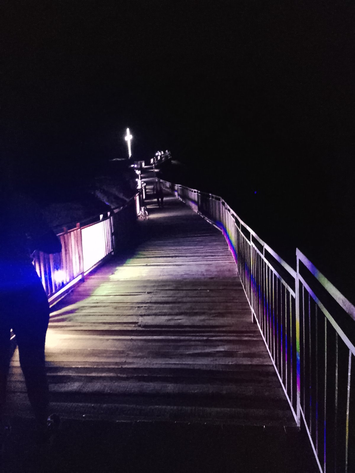 Colorfully lit boardwalk at Provadia's medieval fortress after dark