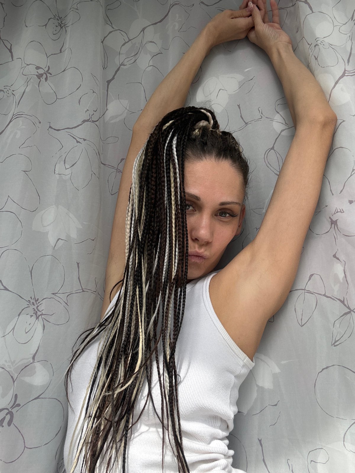 Woman with braided hair poses with tulips at Russian playground