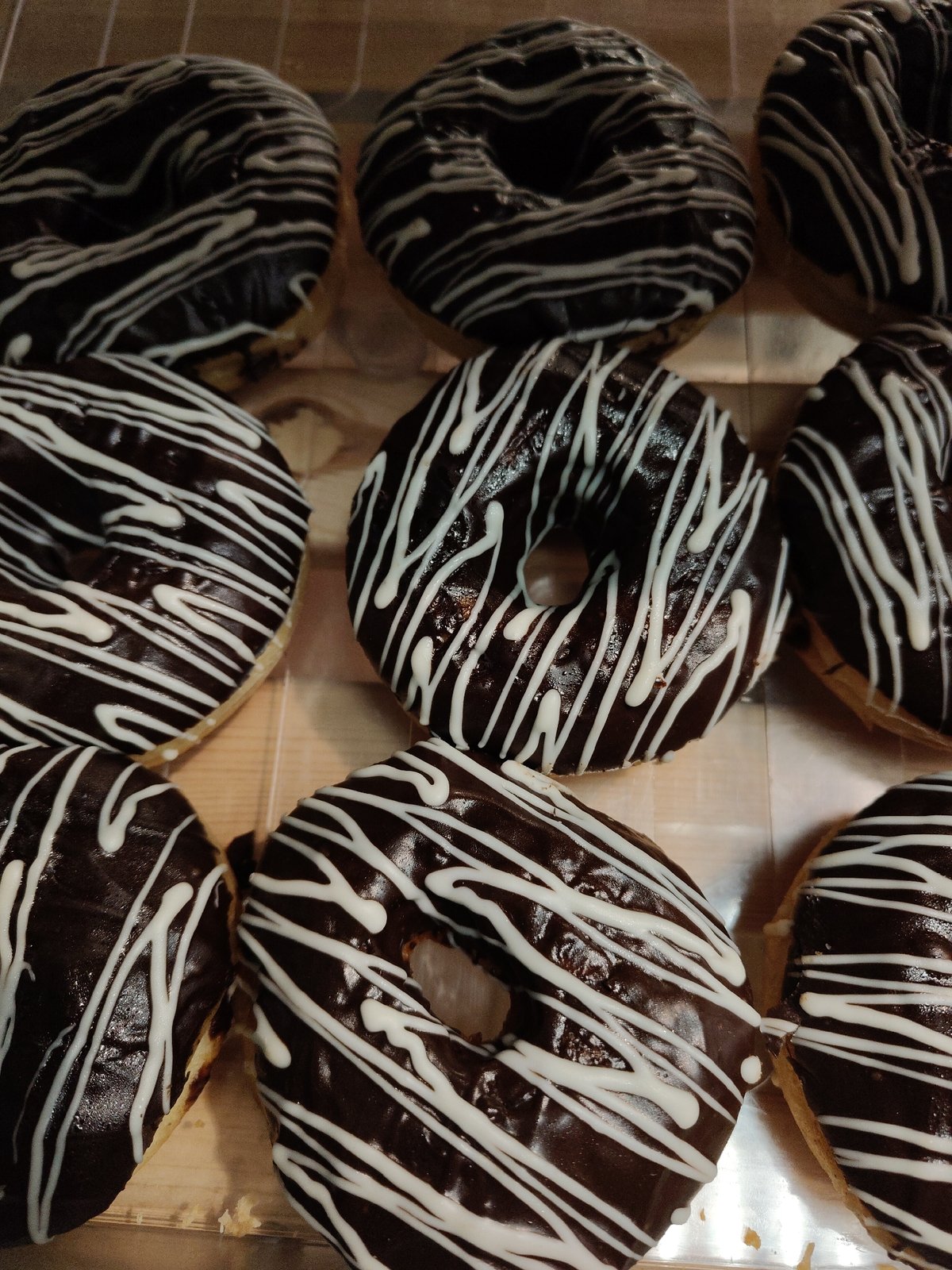 Decorated donuts displayed in case observed by witness