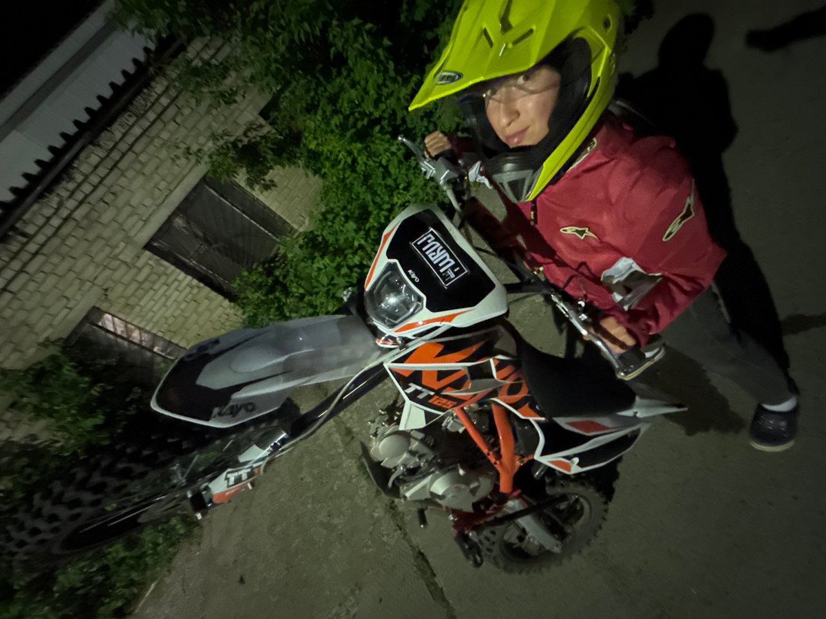 Motocross rider photographed with dirt bike during evening in Chaikovsky