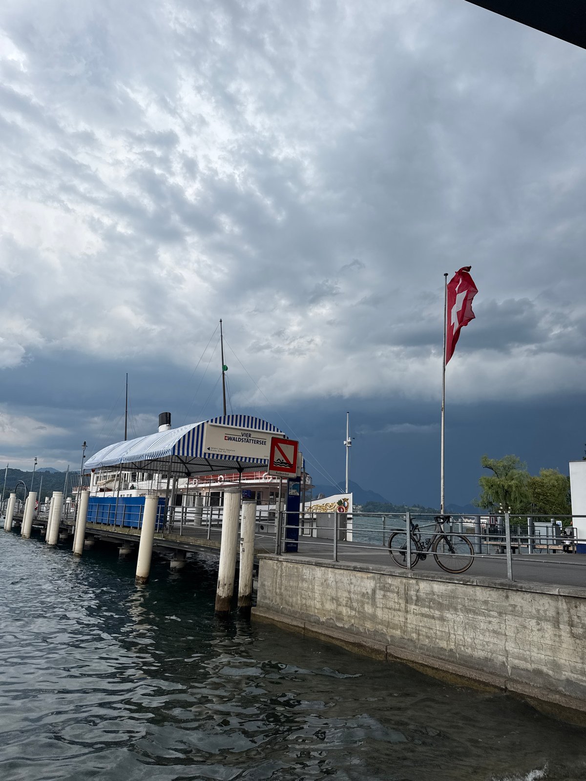 Storm clouds gather over Lucerne's lakefront as ferry sits docked