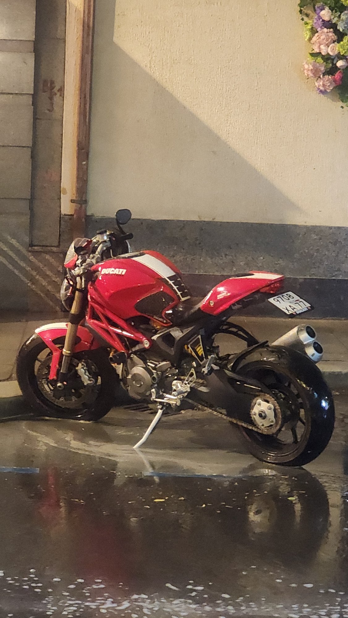 Red Ducati motorcycle spotted parked on wet Moscow street