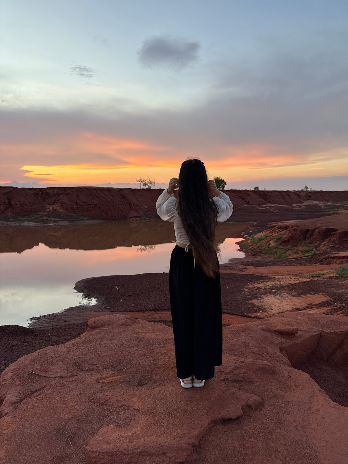 Solitary figure witnesses scenic sunrise/sunset in Mui Ne Vietnam