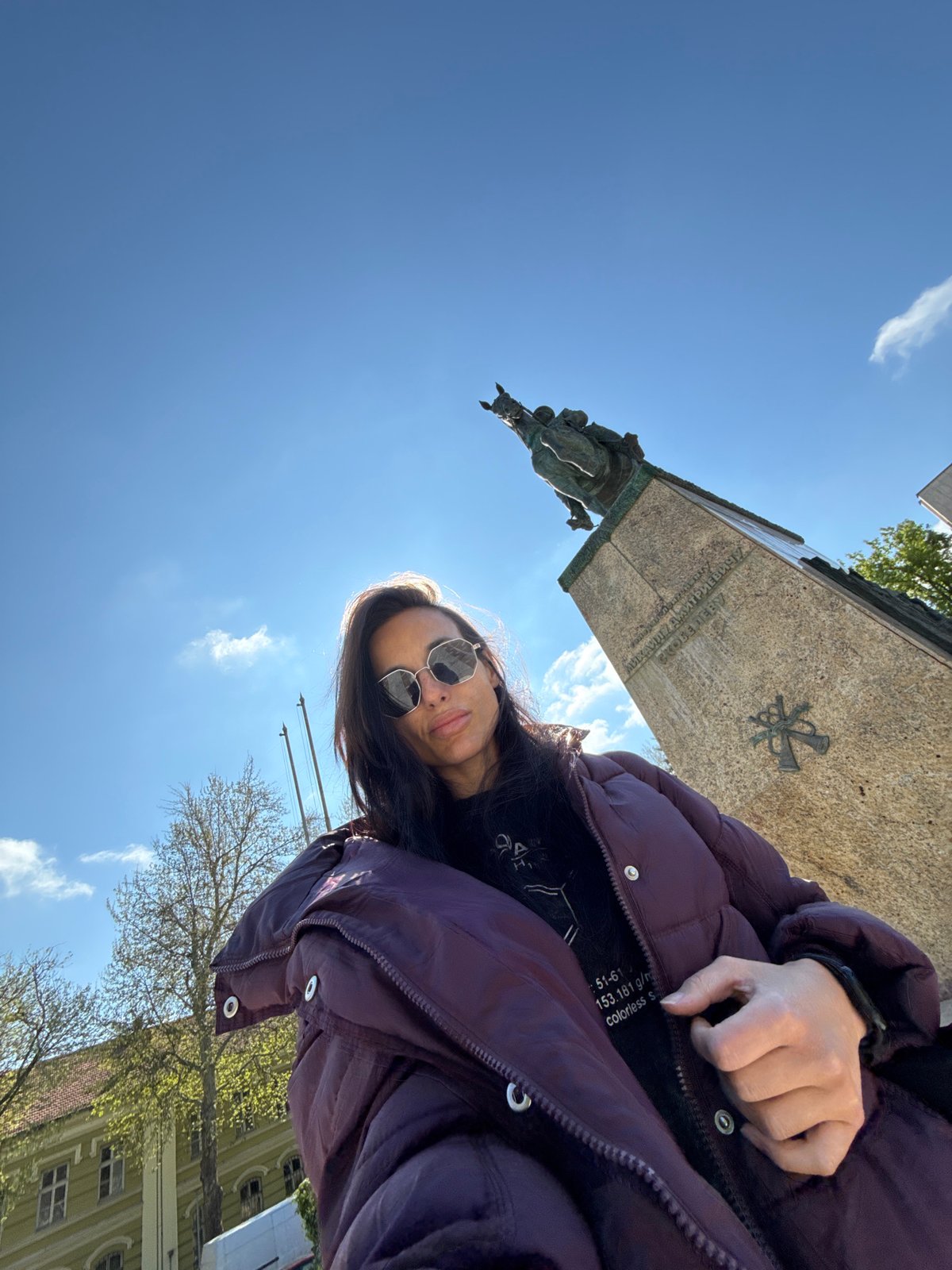 Woman photographs herself at Broken Chains monument in Pleven