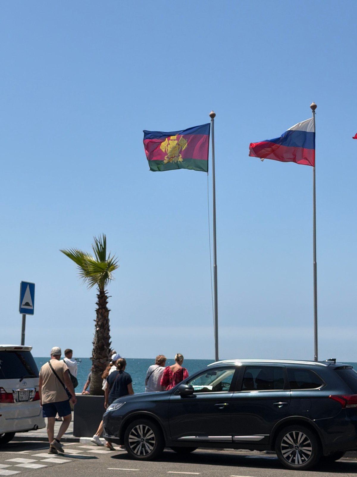 Summer morning beach crowds along Sochi's Black Sea promenade