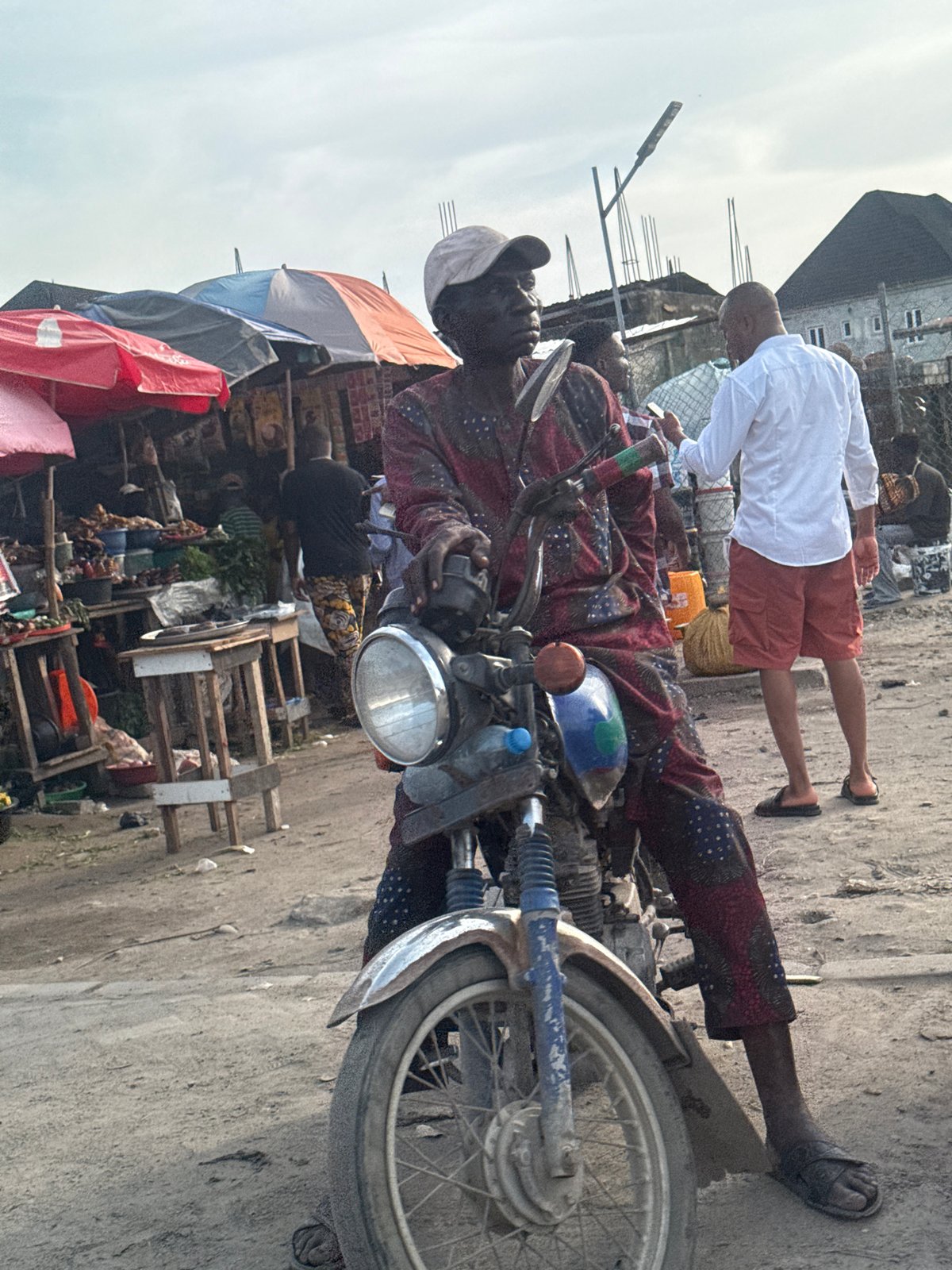 Men photographing and motorcycling in Lekki, Nigeria