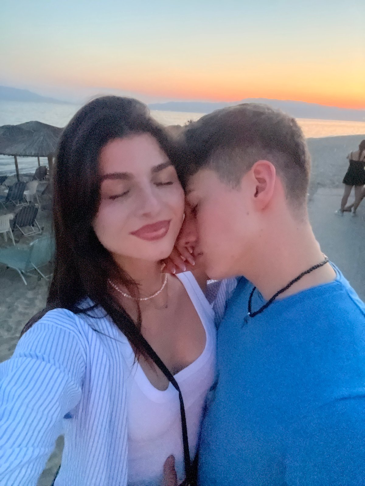Couple shares romantic beach embrace during sunset