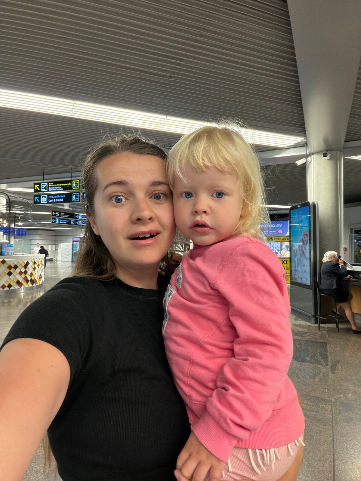 Family with toddler navigates Sochi Airport during overnight hours