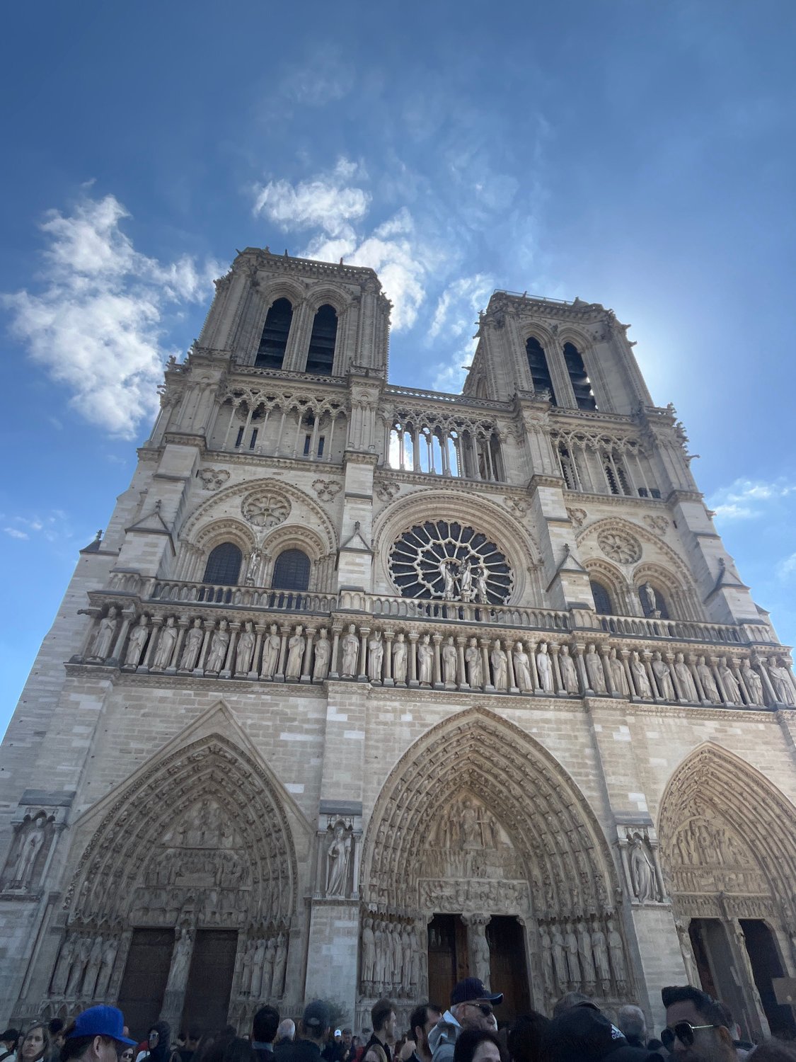 Tourist photographs Notre Dame Cathedral and Seine River in Paris