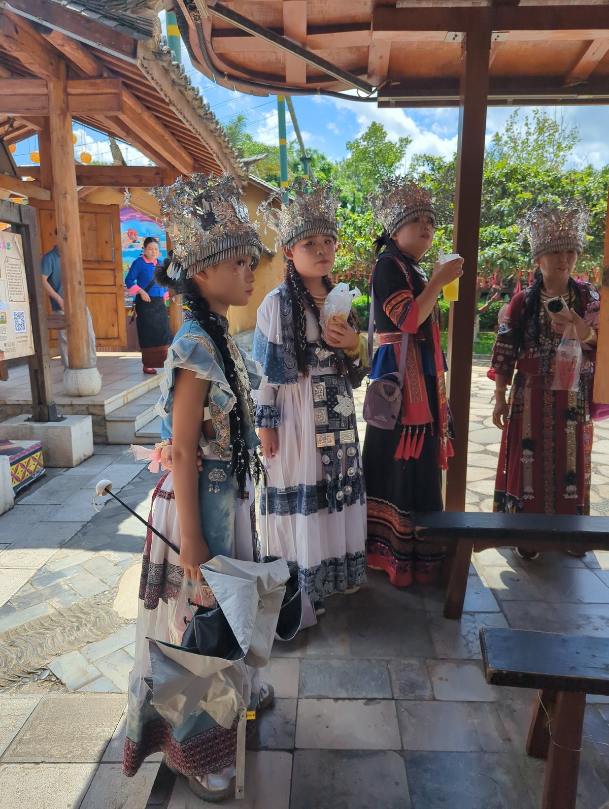Ethnic cultural site in Xishan District, swords, craft displays, and a corgi