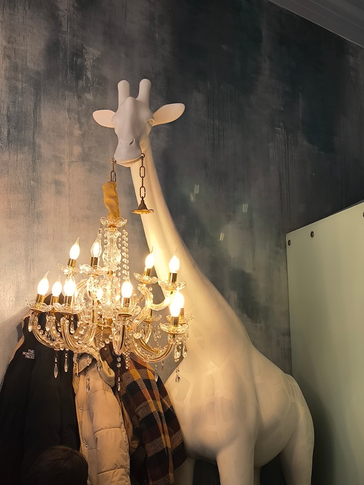 Moscow cafe features large white giraffe statue decoration