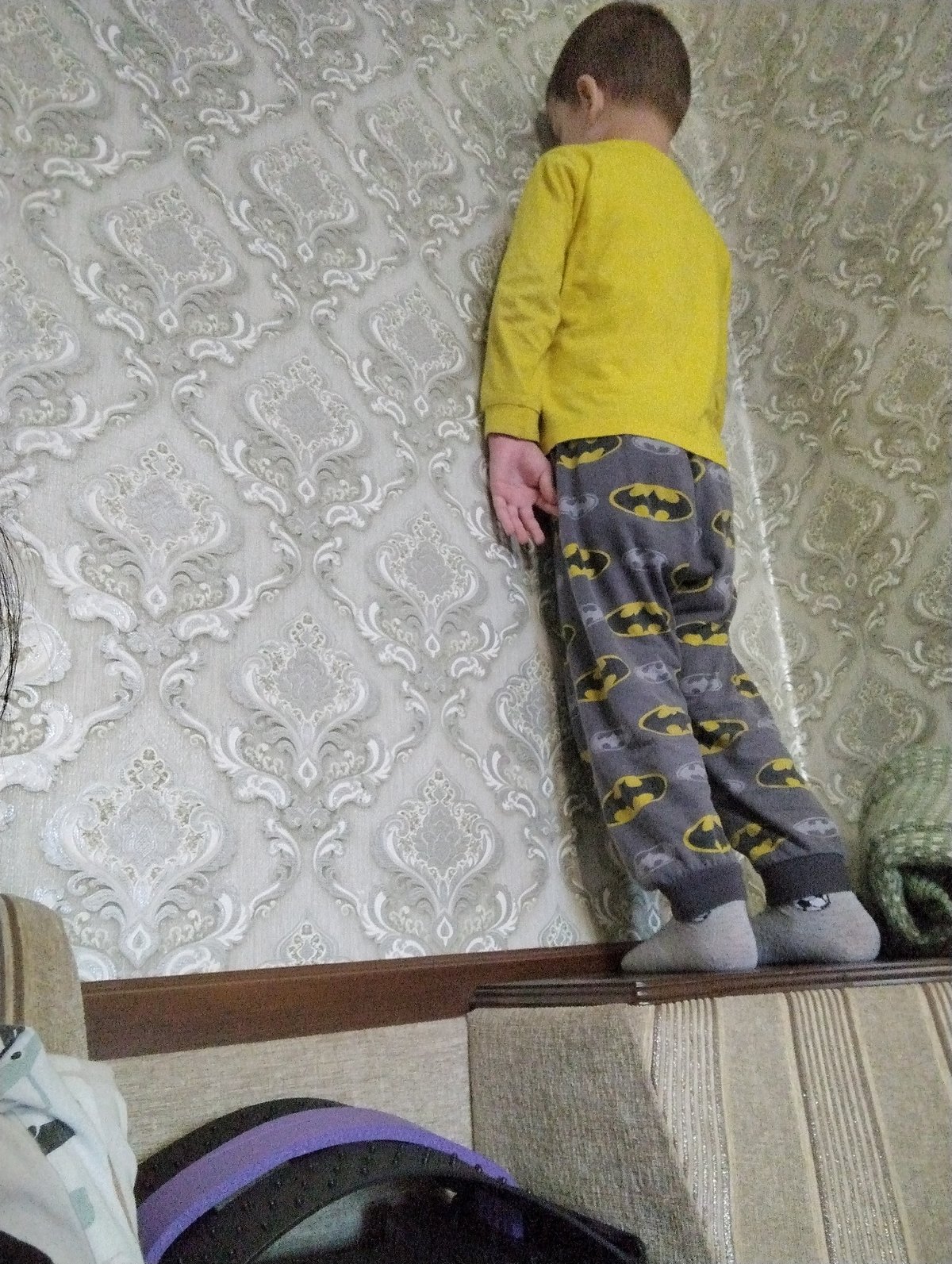 Playful indoor moments in a Kingisepp home, Batman outfit featured