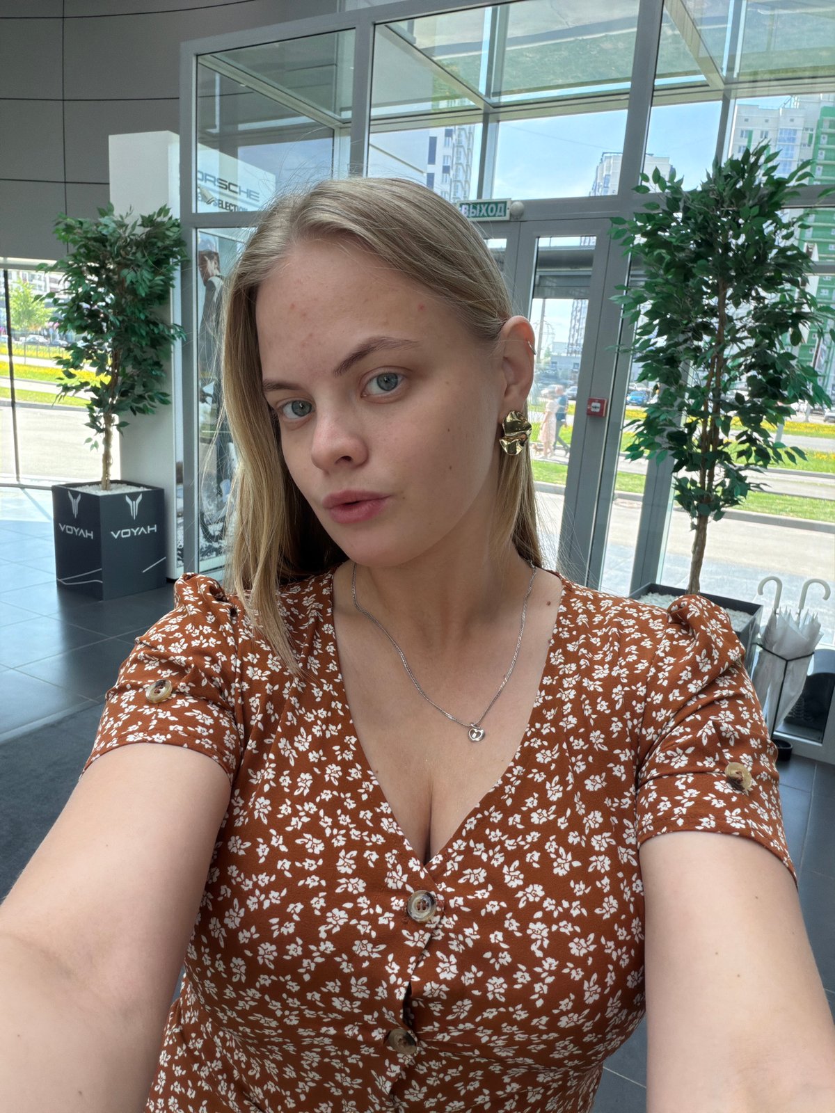 Woman takes selfies in brown floral dress, Izhevsk