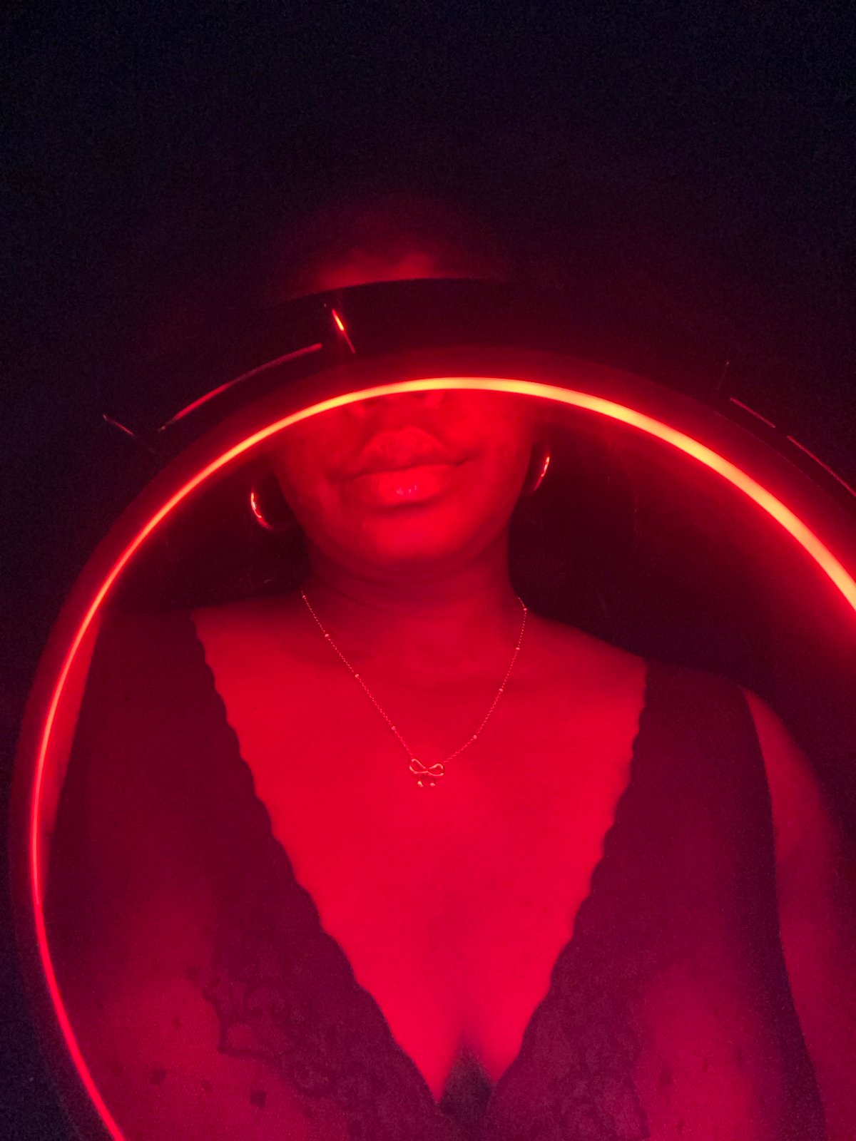 Person photographed under red neon light in Maigizo, Nigeria