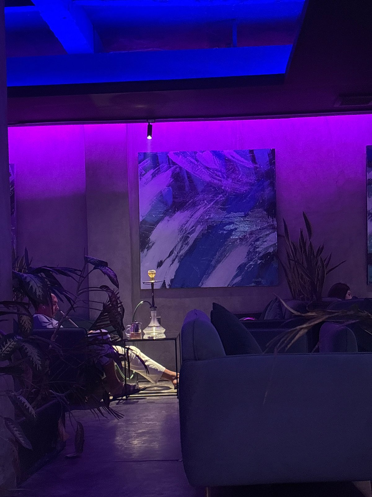 Hookah lounge interior documented in Indonesia with neon lighting