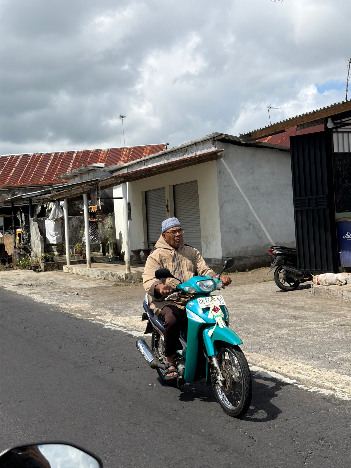 Scooters and traffic along a rural road in Kintamani, Bali