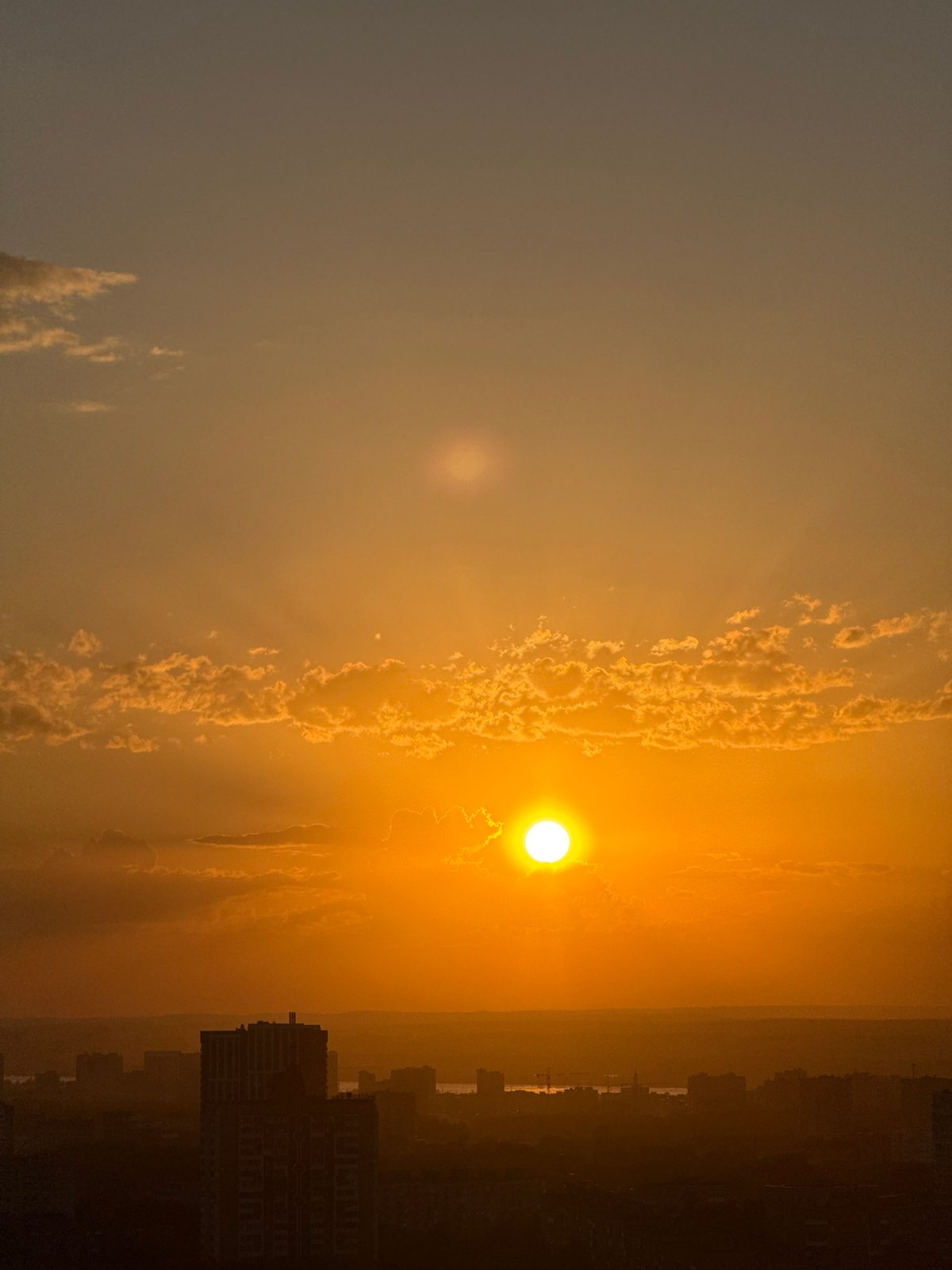 Sunset observed over Shirkovo cityscape with dramatic cloud formations