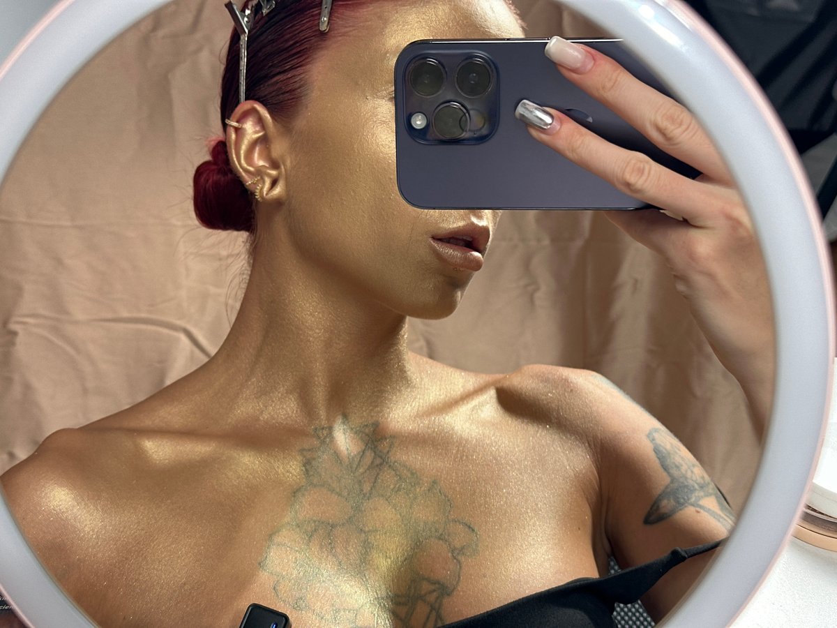 Mirror selfies with golden body shimmer captured in North Kuta