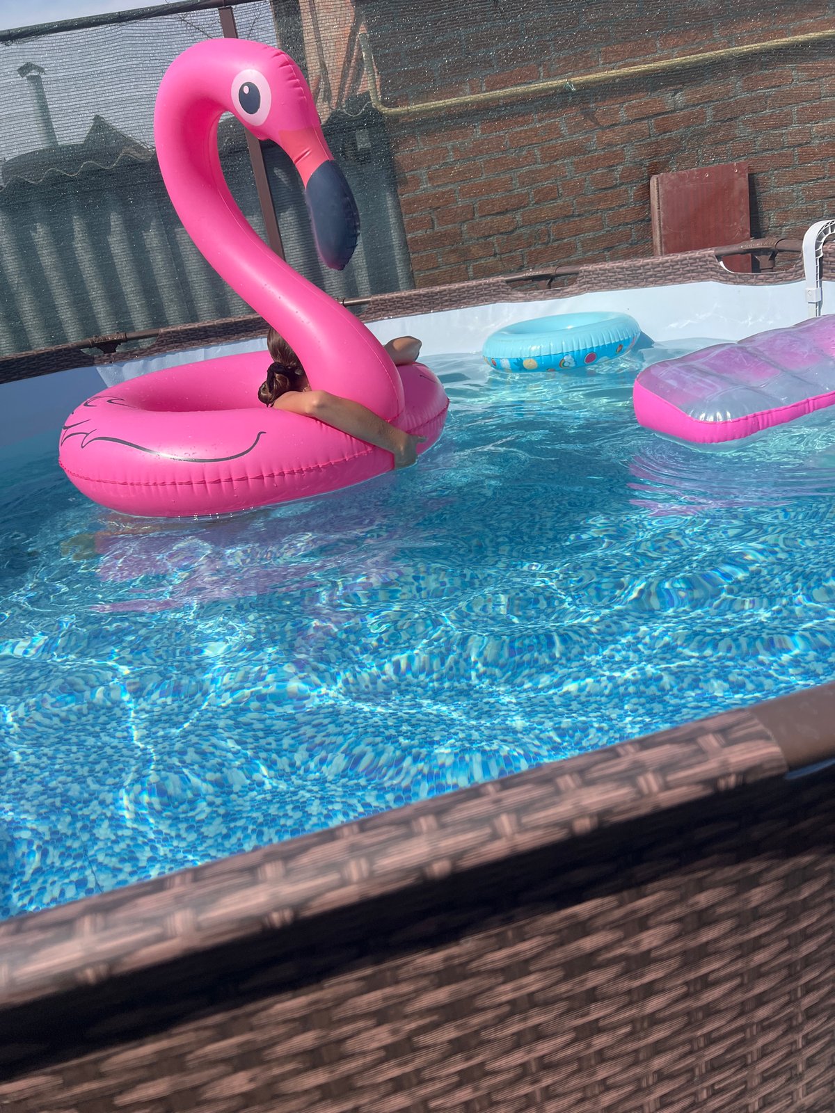 Floating on a pink flamingo inflatable in a Taganrog pool