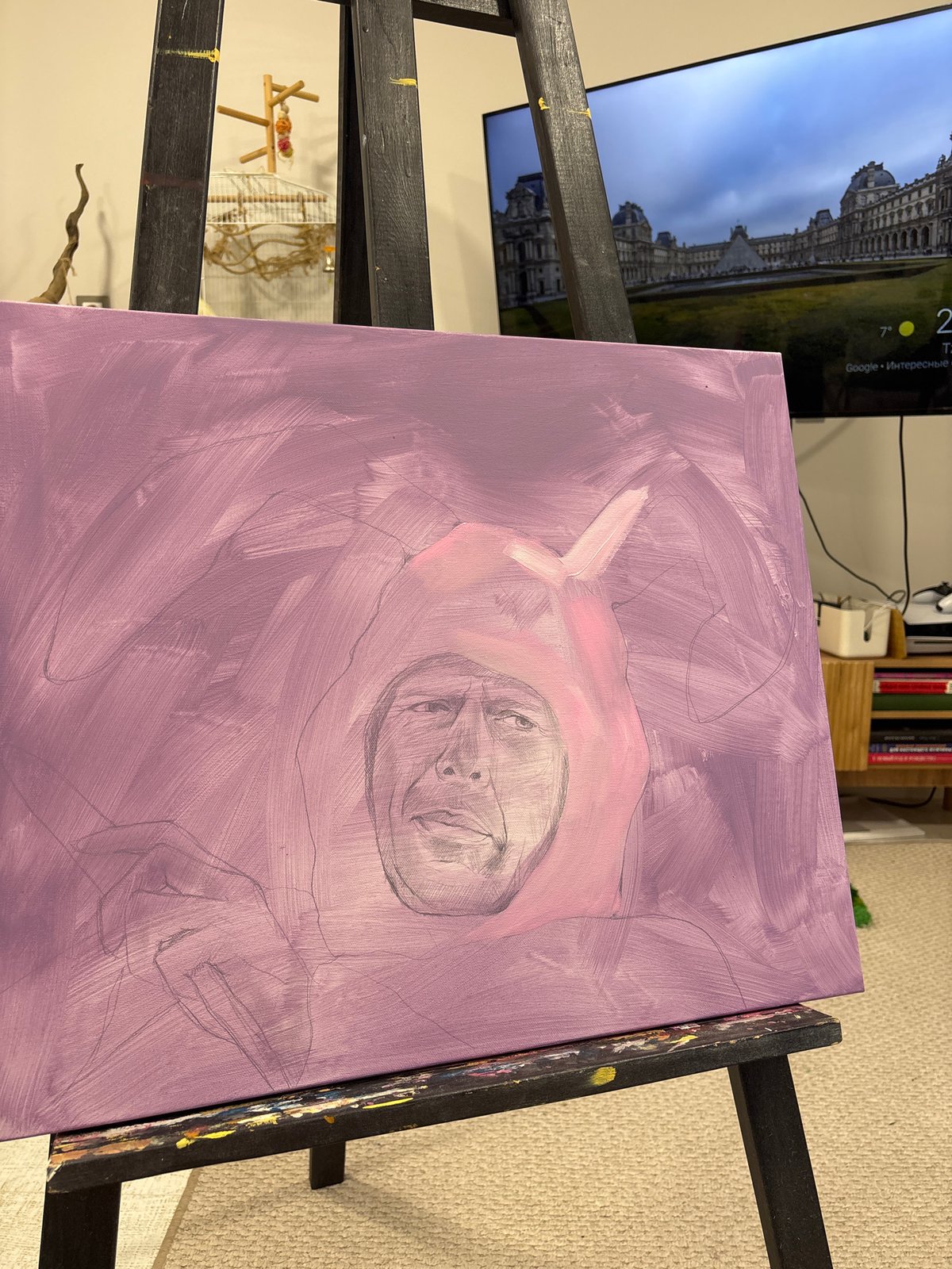 Artist paints portrait while cockatiel watches in Krasnoyarsk studio
