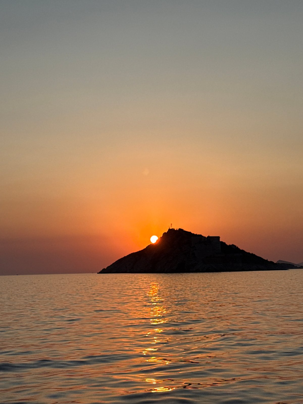 Adriatic sunset behind a silhouetted island, Mirišta
