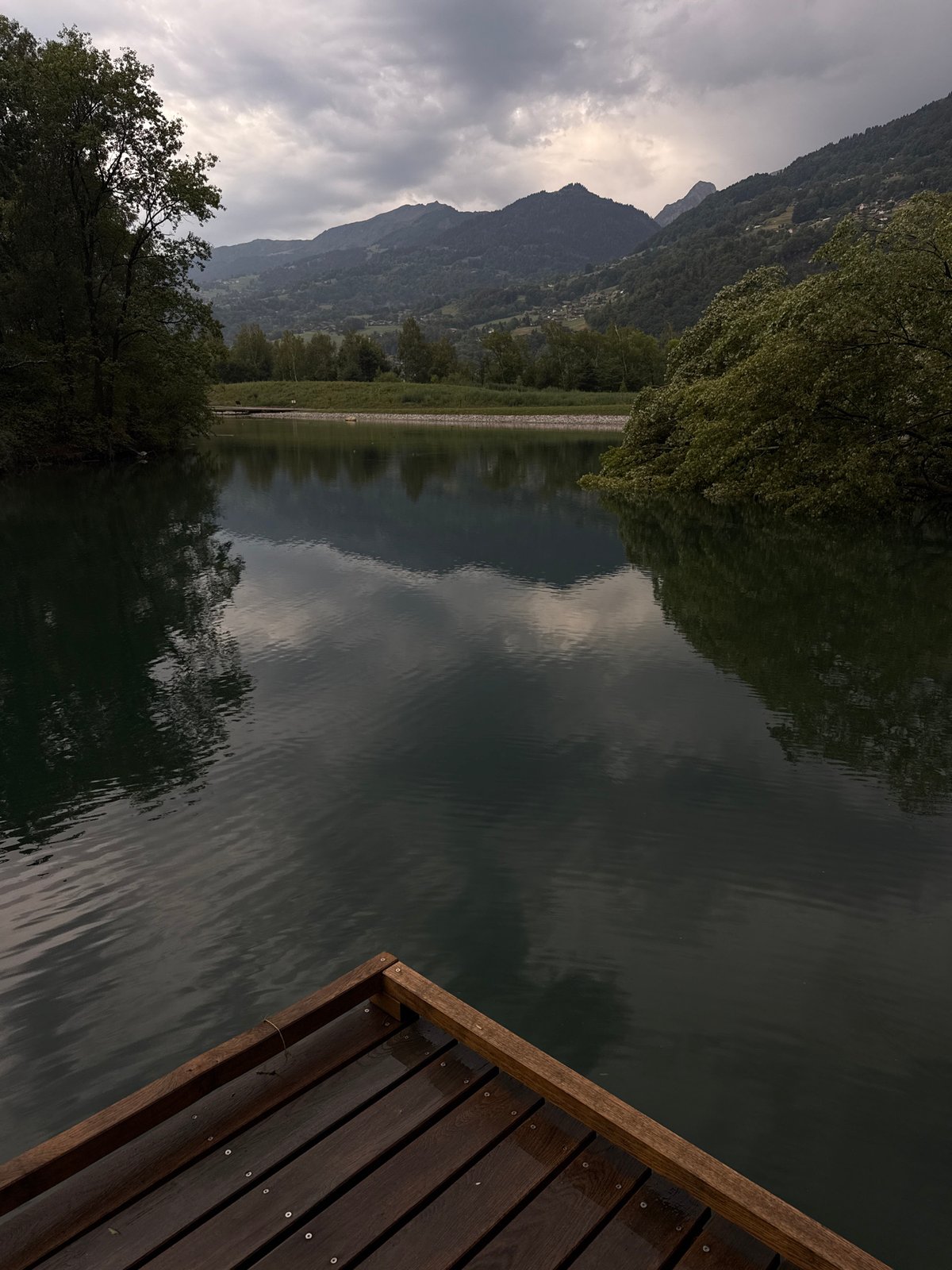Calm mountain waterfront with dock near Sallanches, France