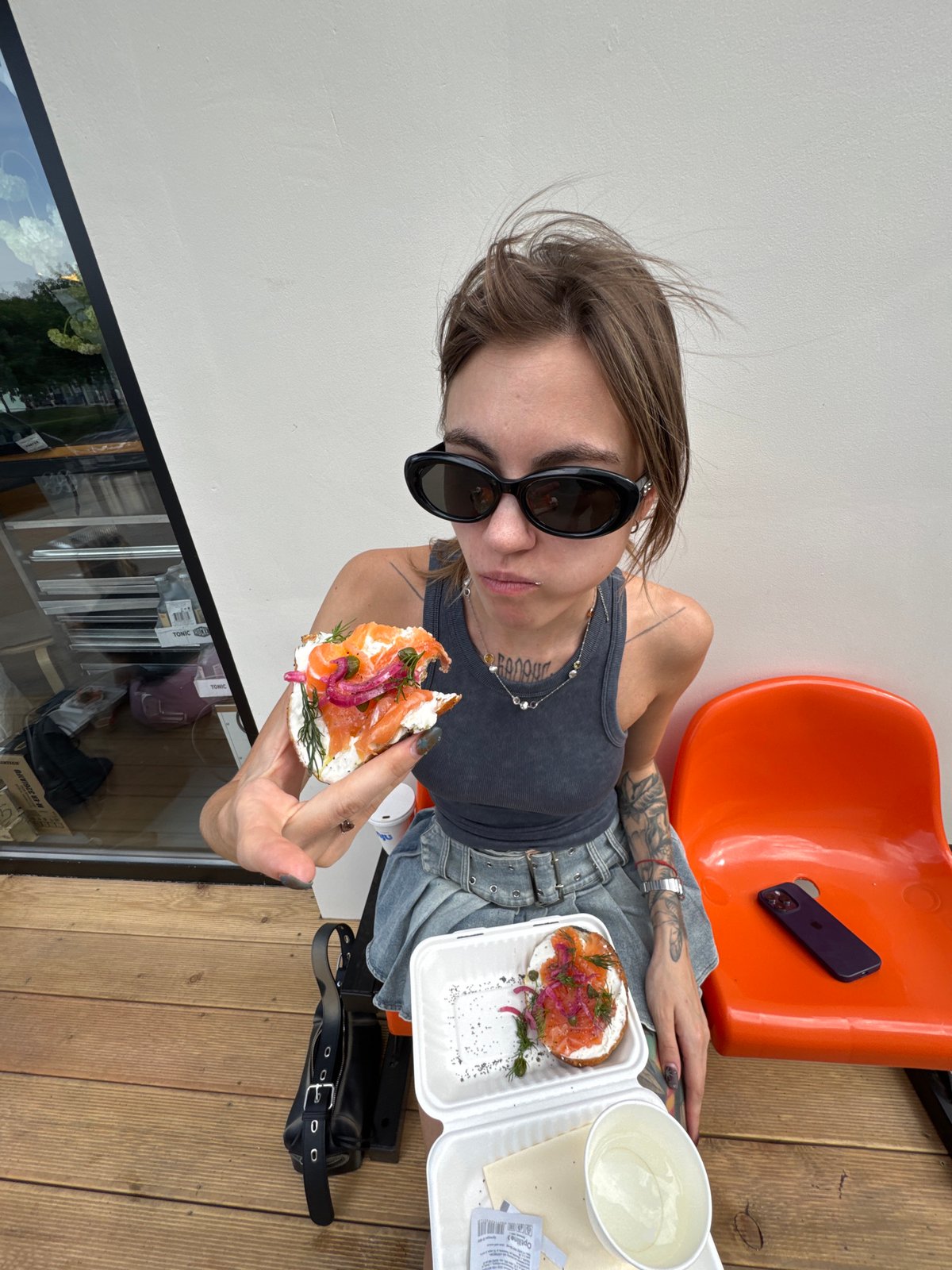Woman enjoys salmon bagel lunch in Moscow
