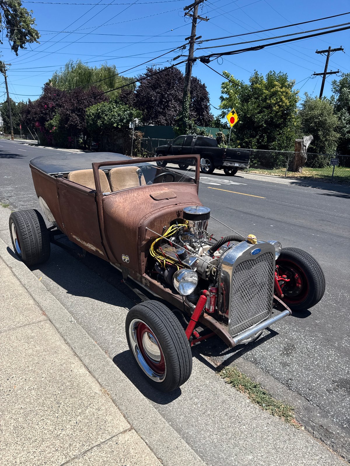 Exposed-engine hot rod parked on a West Sacramento street