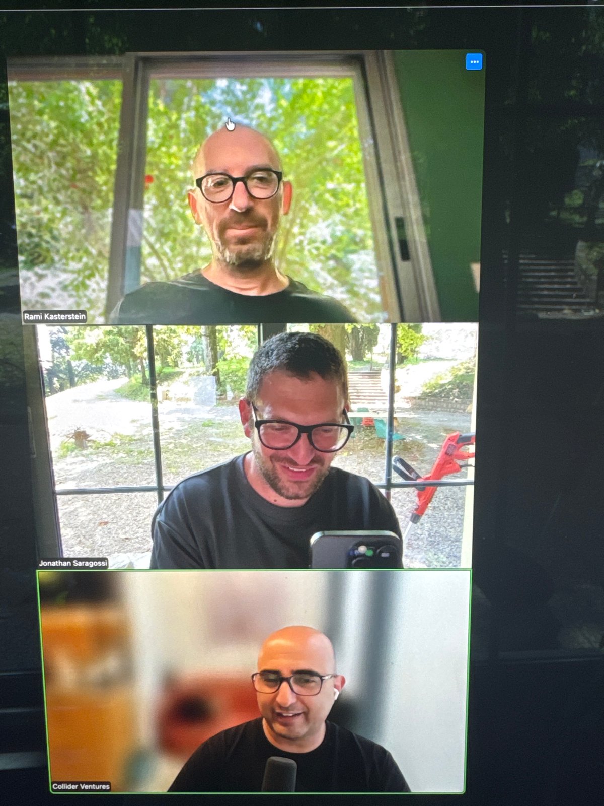 Three-person video conference screen captured in Erba, Italy