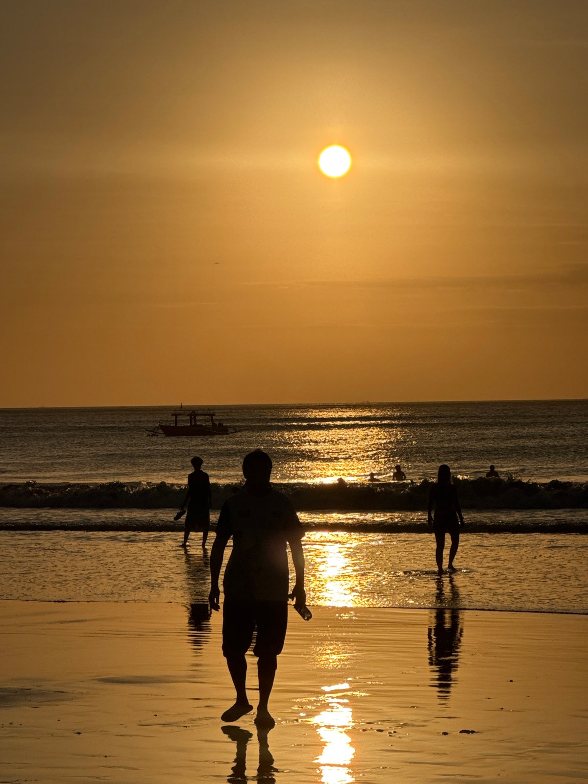 Golden hour at Kuta Selatan: horses, corn vendors, and sunset silhouettes