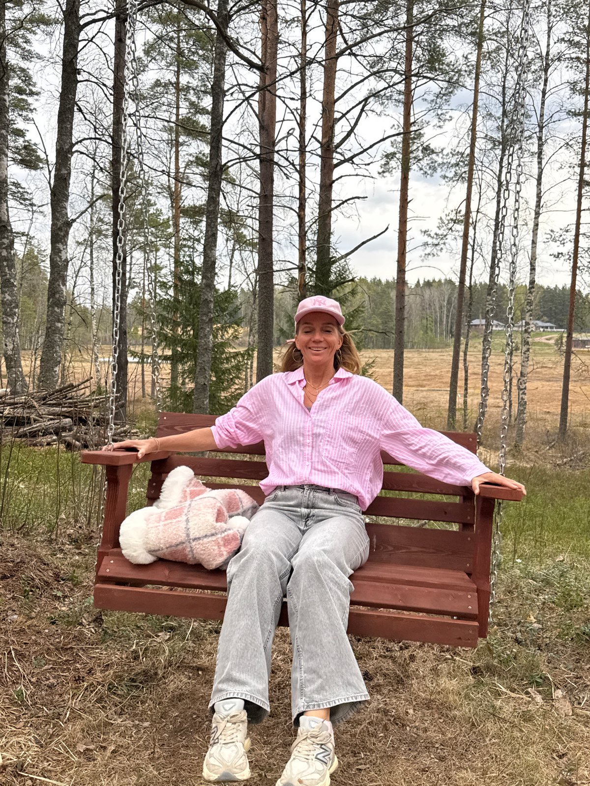 Woman enjoys forest swing near Steklyannyi, Russia