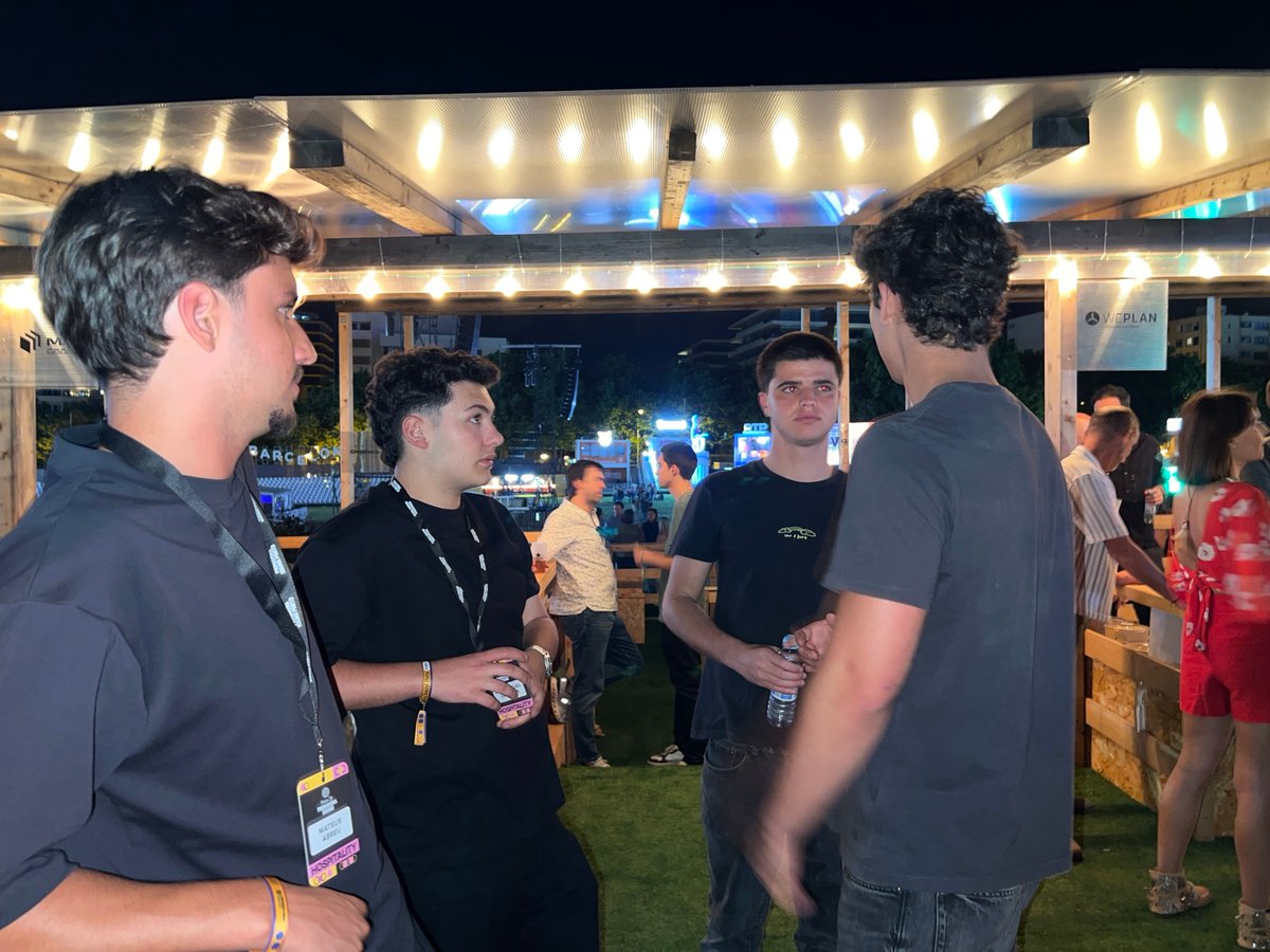 Young men gather for nighttime conversation in Porto