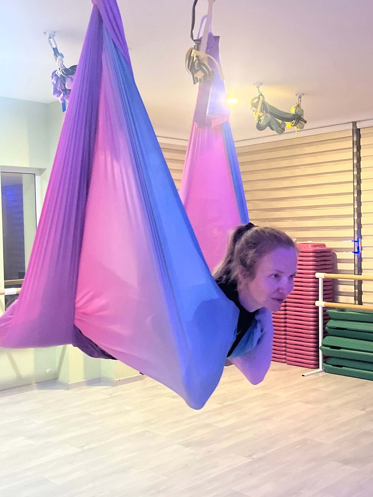 Aerial yoga session in a Budva studio, hammocks and all