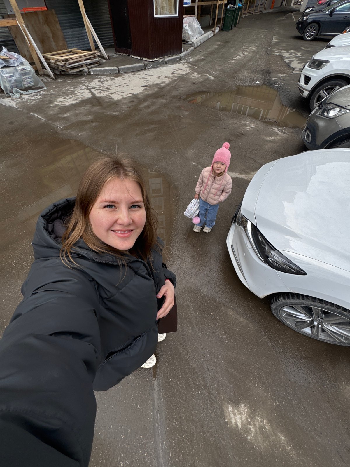 Woman takes selfies while crow scavenges in Perm street