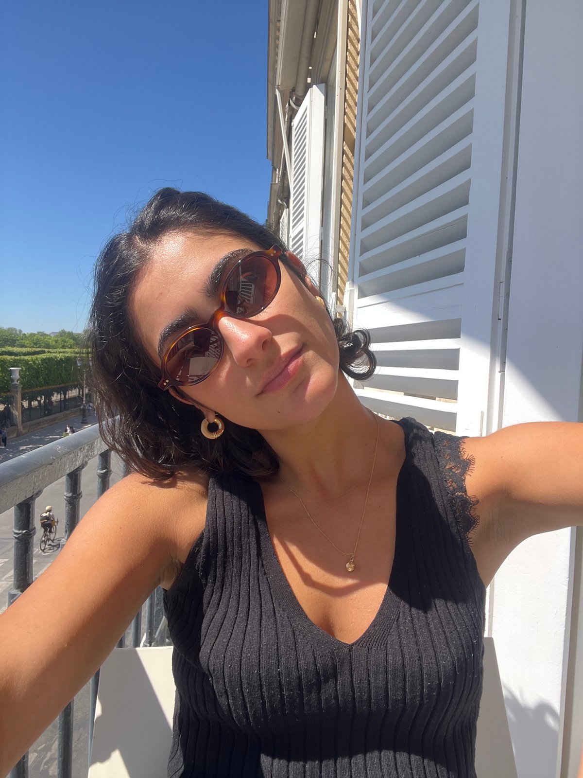 Woman enjoys sunny lunch on Paris balcony