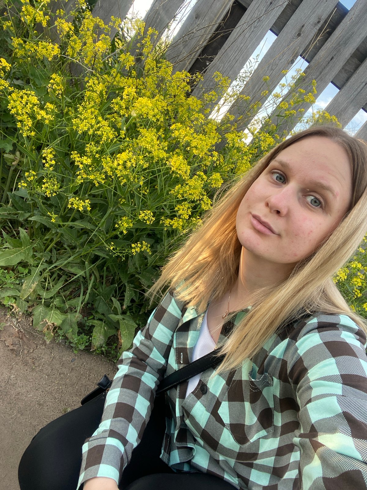 Woman photographs outdoor moments in sunny Chaikovsky, Russia