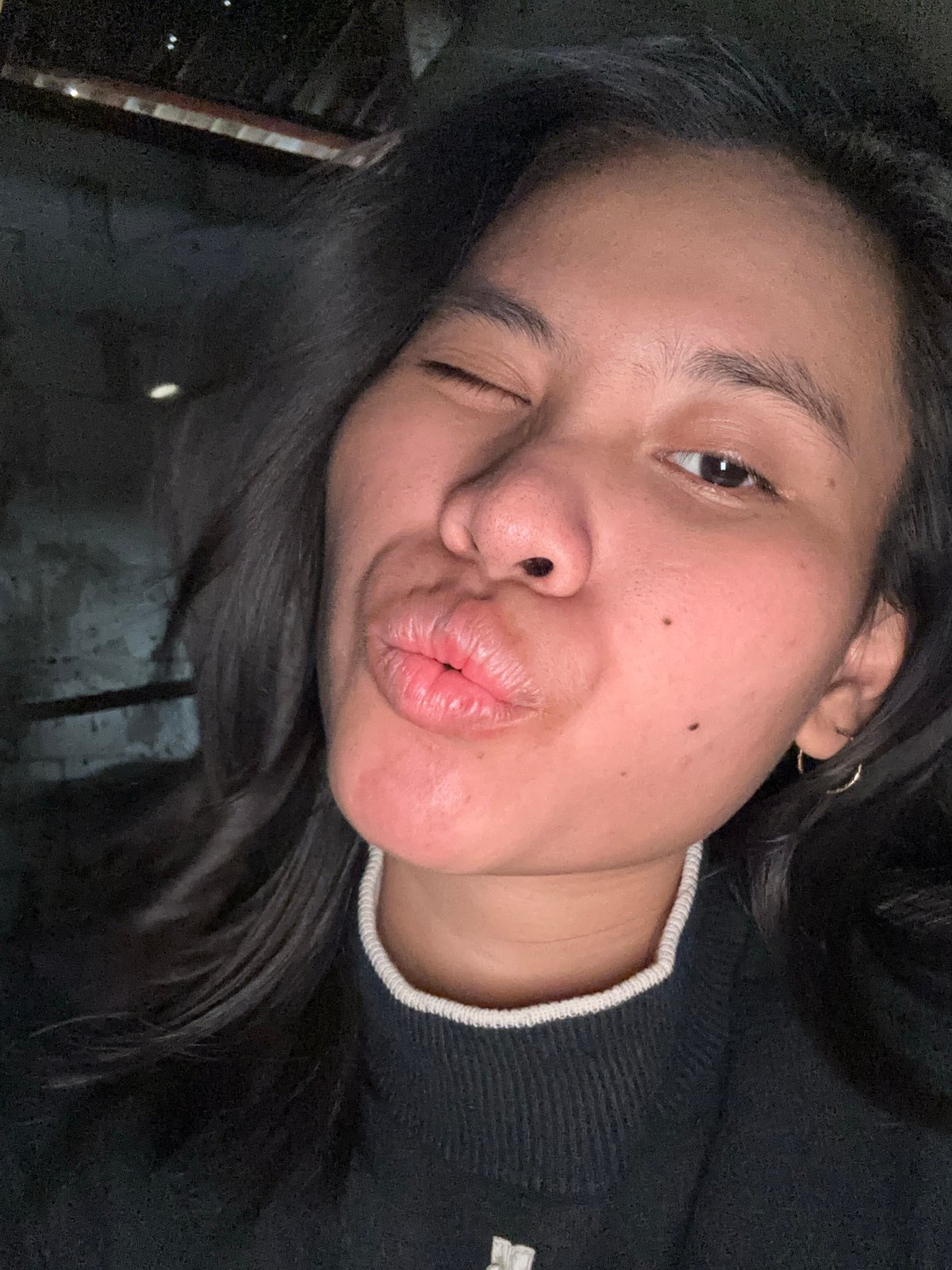 Solo selfie session in a dimly lit East Jakarta room