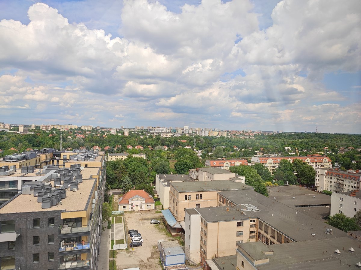 Crane operator documents workday views over Poznan cityscape