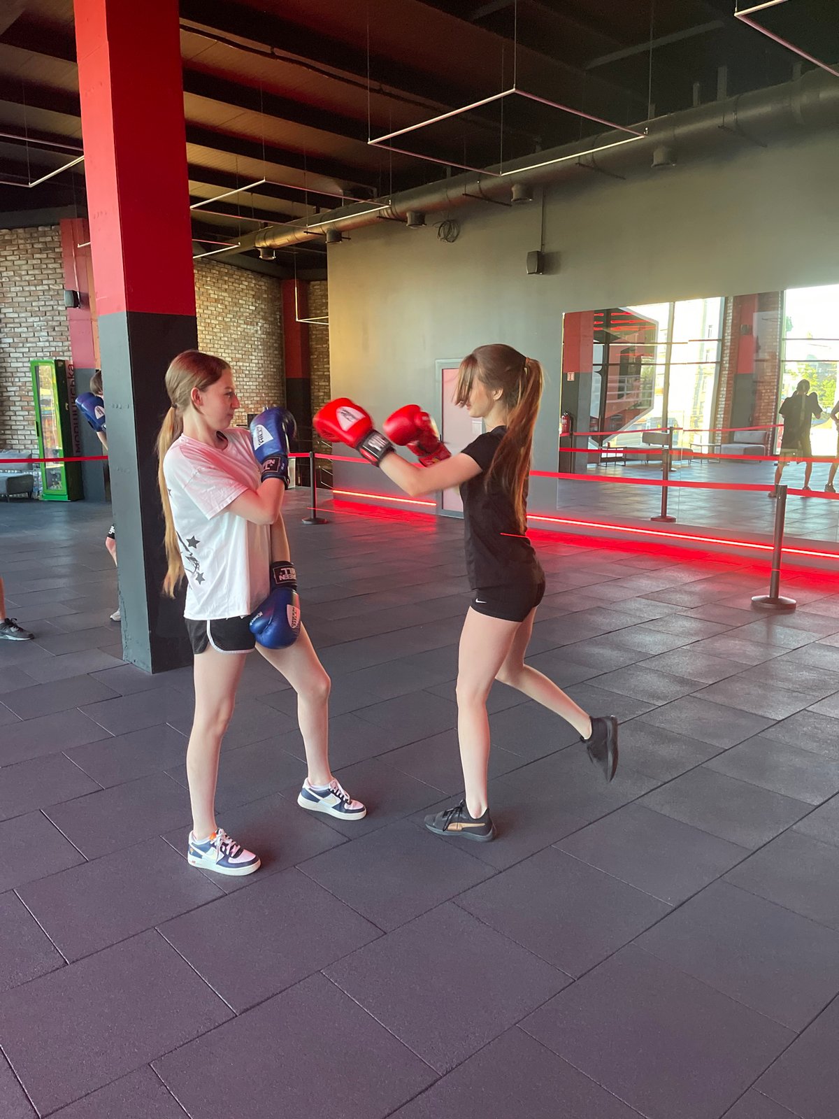 Boxing class in full swing at a sleek industrial gym