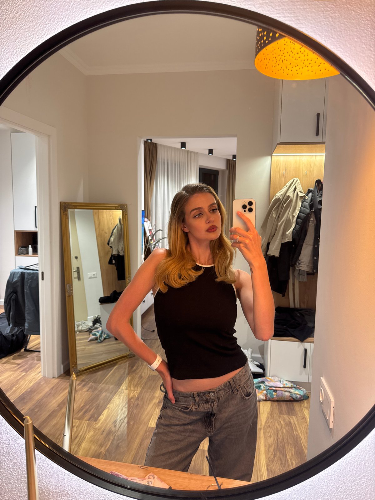 Woman takes mirror selfies during brief photo session