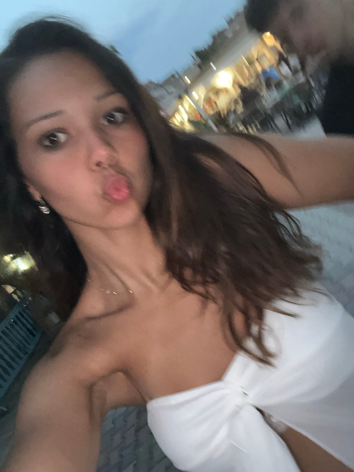 Dusk selfie on a Fanari street with outdoor dining behind