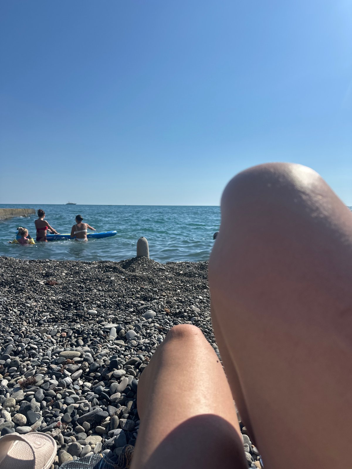 Lazy summer afternoon on Sochi's Black Sea pebble beach