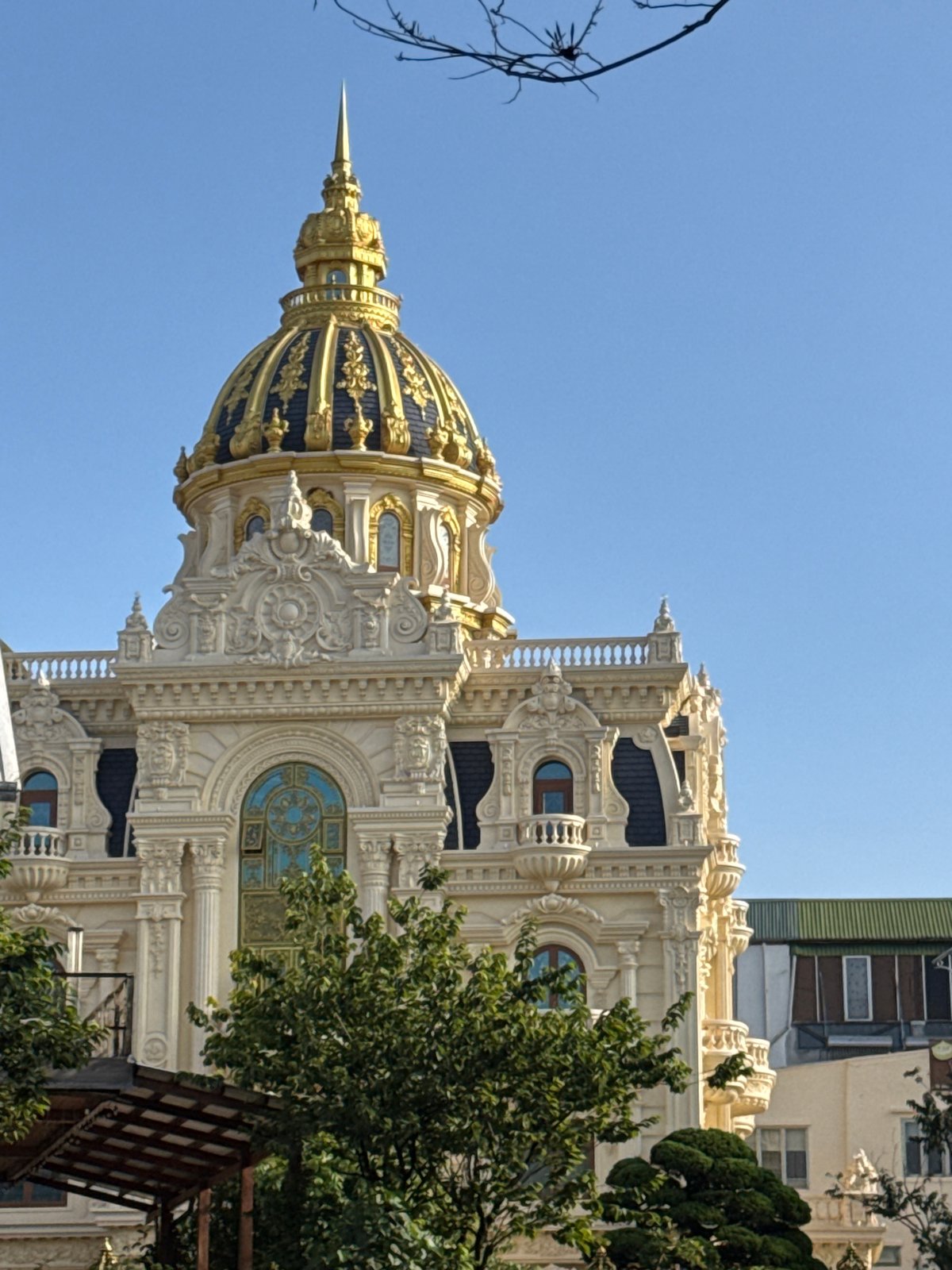 Da Lat's ornate golden dome building, street life nearby