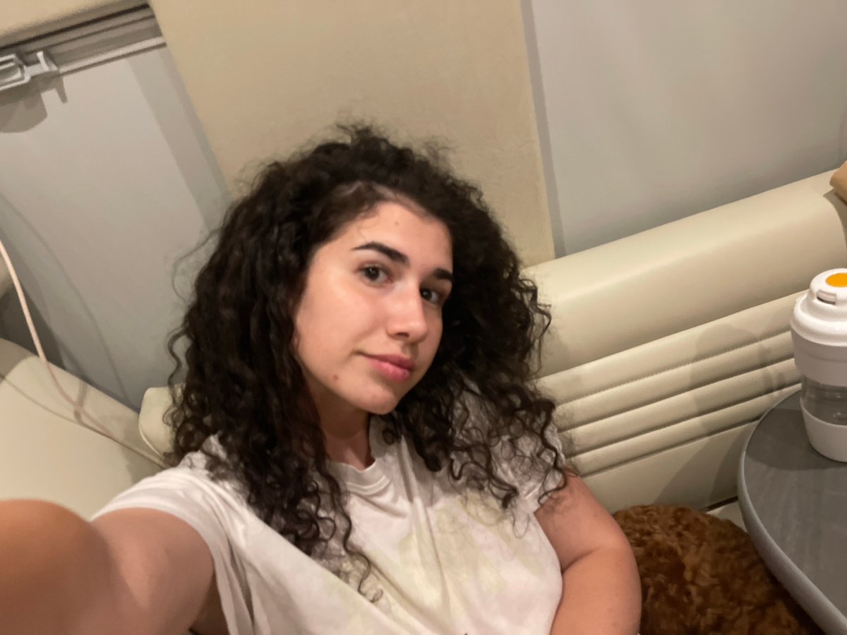 Woman relaxes with dog in RV in Bulgarian village