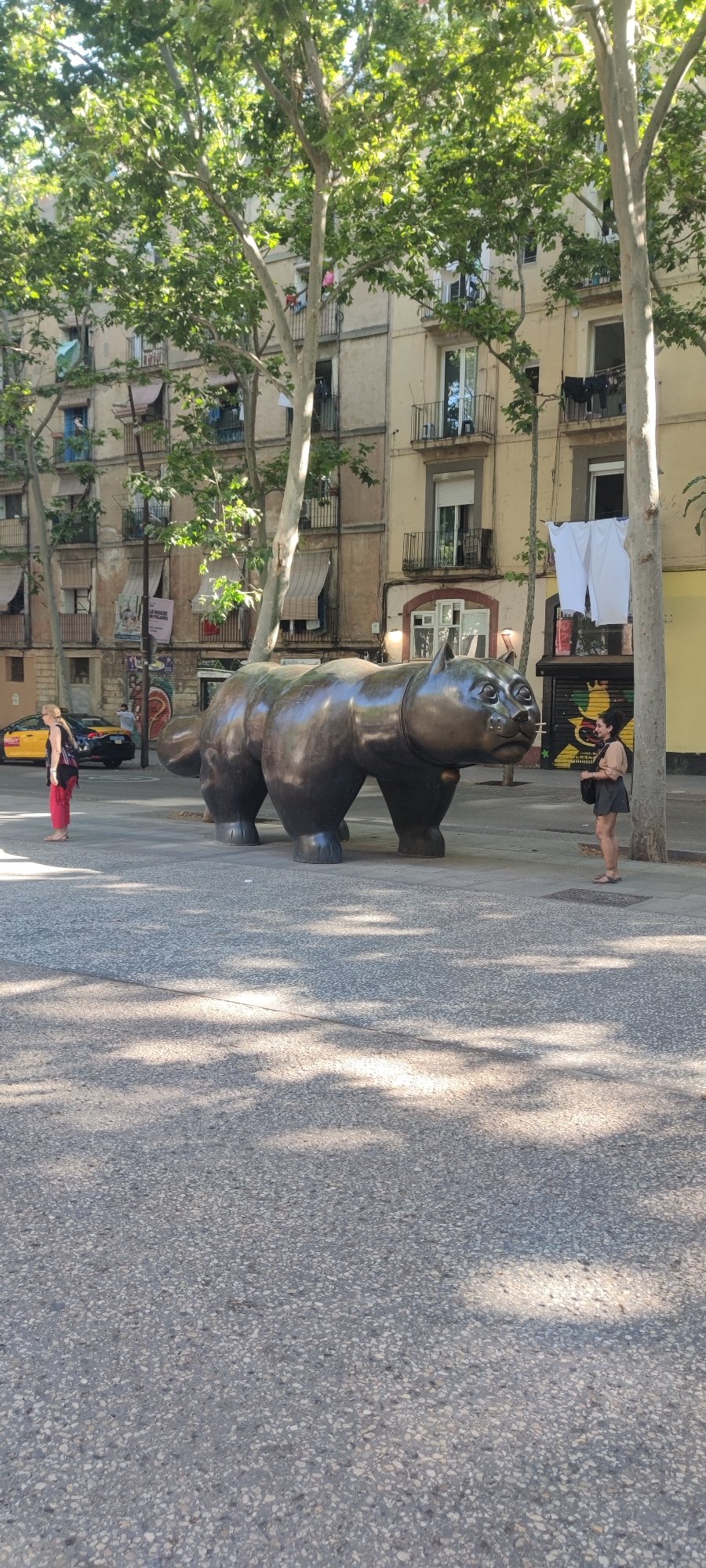 Sunny afternoon street life documented around Barcelona's Botero cat sculpture