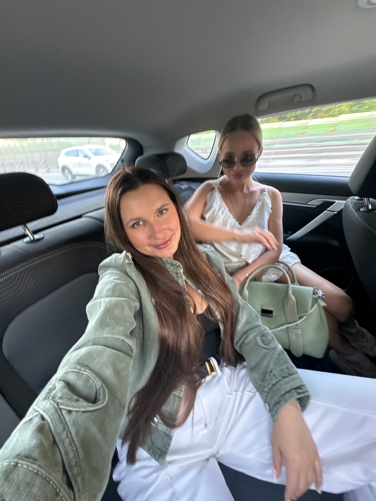 Two women take selfie in vehicle backseat in Gribovo